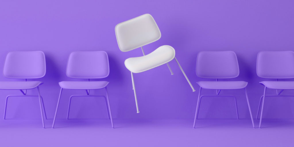 four purple chairs and one white chair
